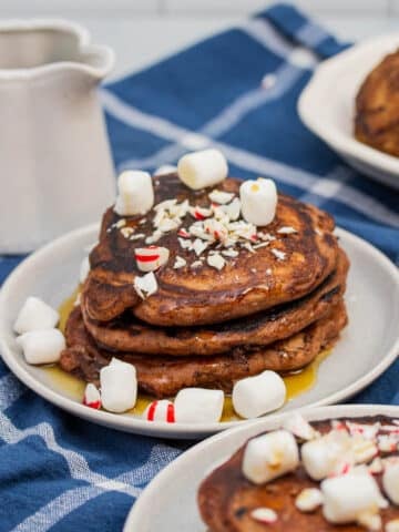 Stack of chocolate chocolate chip pancakes with peppermints and mini marshmallows.