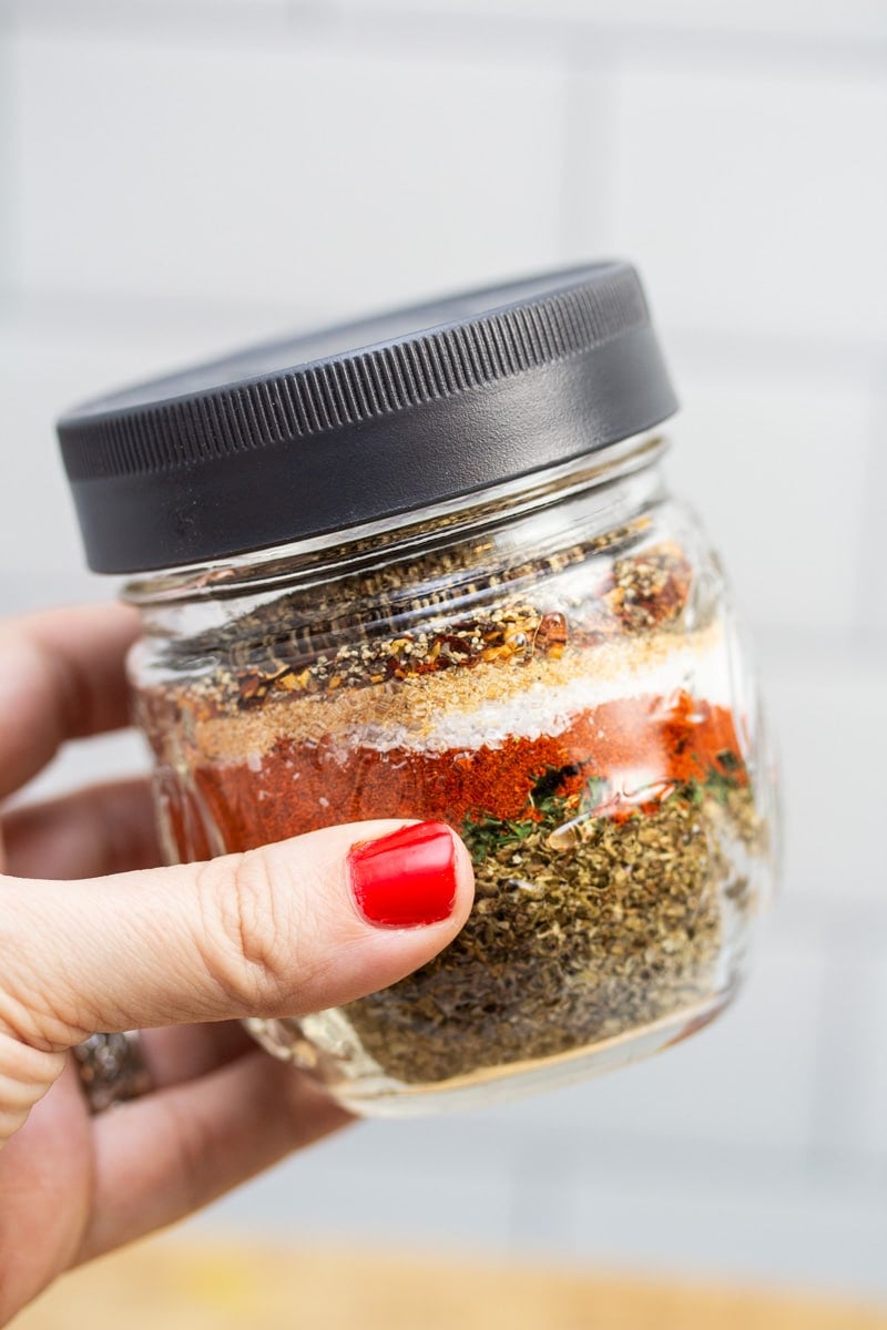 Breakfast sausage seasoning with the ingredients layered in a jar.