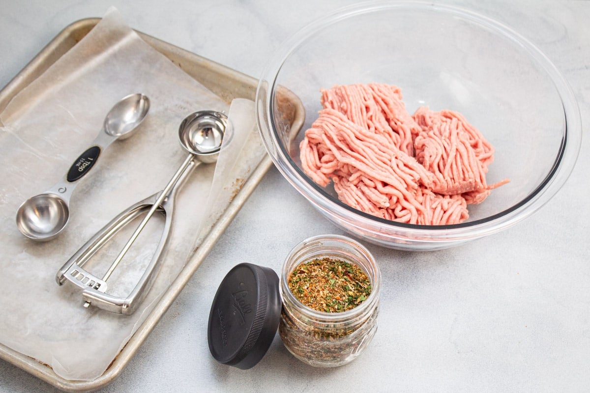 Ingredients and tools for making turkey sausage patties.
