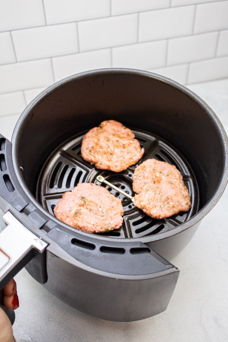 Turkey sausage patties in an air fryer.