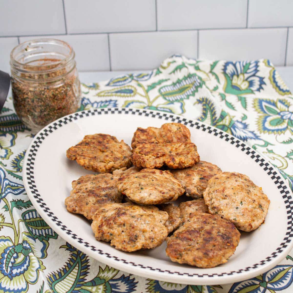 Turkey sausage patties and a jar of breakfast sausage seasoning.