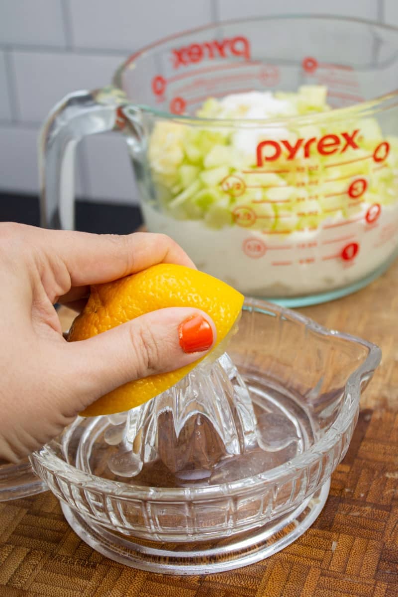 Squeezing the juice from half a lemon.