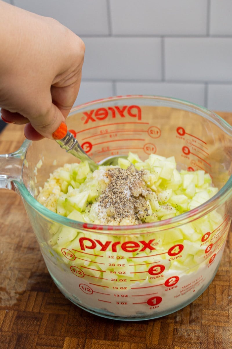 Stirring together ingredients for homemade tzatziki.