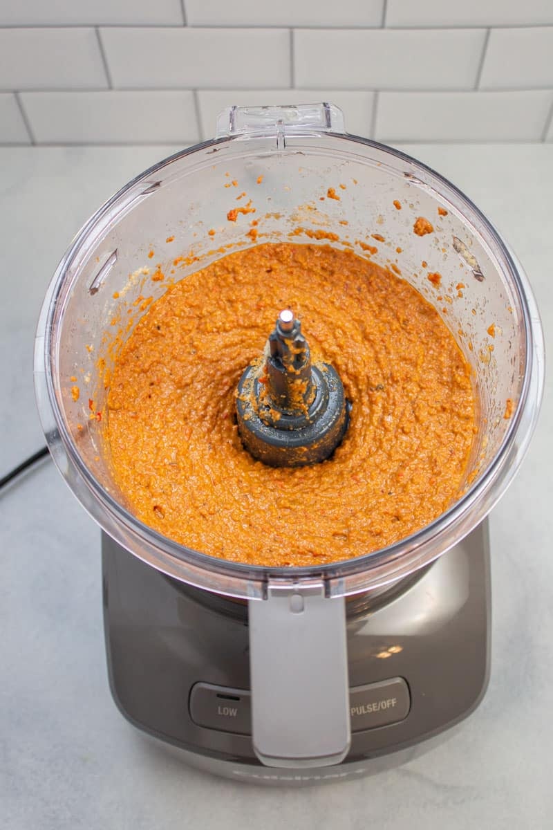 Muhammara (roasted red pepper dip) ingredients pureed together in a food processor.