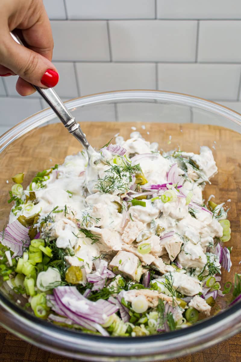 Stirring together ingredients for dill chicken salad.